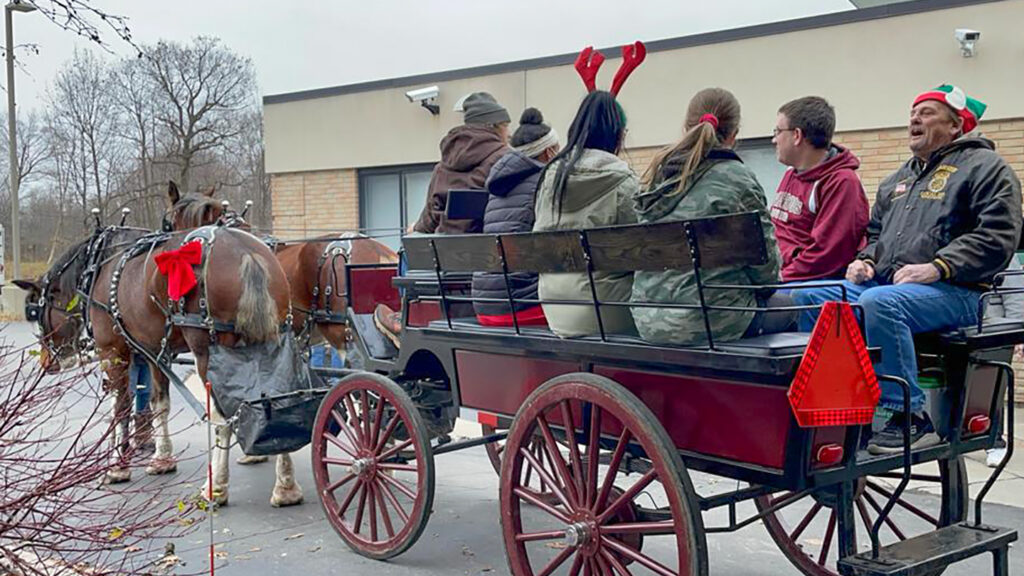 Clydesdales bring Christmas cheer and carriage rides to nursing home residents, families